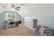 Bright bedroom features natural light, desk, computer and comfortable sitting area at 3335 Hawick Commons Dr, Concord, NC 28027
