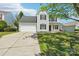 Charming two-story home with a well-maintained lawn, an attached garage, and classic curb appeal at 3335 Hawick Commons Dr, Concord, NC 28027