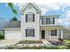 Charming two-story home with white siding, black shutters, and a well-manicured front lawn at 3335 Hawick Commons Dr, Concord, NC 28027