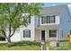 Two-story home with white siding, black shutters, green lawn, and mature shade tree at 3335 Hawick Commons Dr, Concord, NC 28027