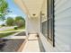 Covered front porch with brick trim and view of front yard at 3335 Hawick Commons Dr, Concord, NC 28027