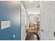 Hallway leading to a dining area featuring wood floors and blue accent wall at 3335 Hawick Commons Dr, Concord, NC 28027