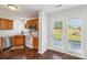 Bright kitchen featuring wood cabinets, white appliances, and access to the outdoor patio at 3335 Hawick Commons Dr, Concord, NC 28027