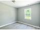 This bedroom boasts modern floors, neutral paint, and a sunlit window at 340 Whitner St, Rock Hill, SC 29730