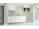 Cozy kitchen featuring gray walls, white cabinets, countertops, and a stainless steel sink at 340 Whitner St, Rock Hill, SC 29730