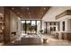 Bright living room with floor-to-ceiling sliding glass doors and modern coffered ceilings overlooking the outdoor living spaces at 3630 Foxcroft Rd, Charlotte, NC 28211