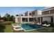 Beautiful backyard featuring a large rectangular pool with lounge chairs and lush landscaping at 3630 Foxcroft Rd, Charlotte, NC 28211