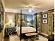 Comfortable bedroom with four-poster bed, neutral walls, ceiling fan, and stylish decor at 3718 Barclay Downs Dr, Charlotte, NC 28209