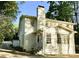Charming white exterior with brick chimney and beautifully landscaped yard at 3718 Barclay Downs Dr, Charlotte, NC 28209