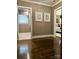 Spacious hallway with hardwood flooring, neutral walls, and doorways leading to other rooms at 3718 Barclay Downs Dr, Charlotte, NC 28209