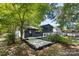 Spacious backyard featuring a newly installed concrete patio with mulch border at 3801 Woodleaf Rd, Charlotte, NC 28205