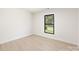 Bright bedroom with a large window and light wood floors at 3801 Woodleaf Rd, Charlotte, NC 28205