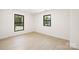 Bright bedroom with two windows, light wood floors and fresh white paint at 3801 Woodleaf Rd, Charlotte, NC 28205