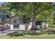 Charming updated two-story home featuring a large front yard and mature shade tree at 3801 Woodleaf Rd, Charlotte, NC 28205