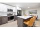 Modern kitchen featuring stainless appliances, white cabinets, and a center island with seating at 3801 Woodleaf Rd, Charlotte, NC 28205