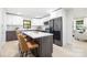 Stylish kitchen with island, seating, stainless appliances, and modern cabinets at 3801 Woodleaf Rd, Charlotte, NC 28205