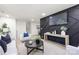 Living room with a black accent wall, modern furnishings, and light wood flooring at 3801 Woodleaf Rd, Charlotte, NC 28205