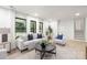Bright and airy living room featuring large windows and modern neutral-toned furniture at 3801 Woodleaf Rd, Charlotte, NC 28205