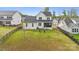 Expansive backyard featuring a lush lawn, minimal landscaping, and a black iron fence at 4012 Spring Cove Way, Belmont, NC 28012