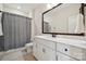 Bathroom featuring a modern sink, vanity, toilet, and a shower with grey curtains at 4012 Spring Cove Way, Belmont, NC 28012