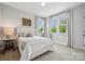Comfortable bedroom featuring carpeted floor, large windows, and a decorative painting that enhances its appeal at 4012 Spring Cove Way, Belmont, NC 28012