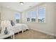Bright bedroom featuring a comfortable bed, carpeted floor, and multiple windows offering lots of natural light at 4012 Spring Cove Way, Belmont, NC 28012
