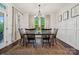 Traditional dining room featuring wainscoting, a wooden table, and natural light at 4012 Spring Cove Way, Belmont, NC 28012