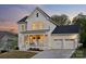 Attractive two-story home with a welcoming front porch and a convenient three-car garage at 4012 Spring Cove Way, Belmont, NC 28012