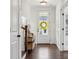Bright foyer featuring hardwood floors, decorative wainscoting, and a front door with a cheerful wreath at 4012 Spring Cove Way, Belmont, NC 28012
