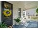Charming covered front porch with rocking chairs, plants, and a welcoming wreath on the front door at 4012 Spring Cove Way, Belmont, NC 28012