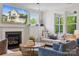 Comfortable living room featuring a fireplace, stylish seating, and a view of the outdoor landscape at 4012 Spring Cove Way, Belmont, NC 28012