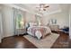 Spacious main bedroom suite featuring tray ceiling, neutral decor, and plush bedding at 4012 Spring Cove Way, Belmont, NC 28012