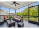 View of a screened-in porch with outdoor furniture and a view of the backyard at 4012 Spring Cove Way, Belmont, NC 28012