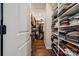 View of a walk-in closet with hardwood floors and custom shelving at 4012 Spring Cove Way, Belmont, NC 28012