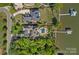 An aerial view of a luxury home with a backyard pool and private boat dock on the water at 4109 Arbor Spring Ct, Belmont, NC 28012