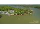 Beautiful aerial shot of lakefront properties surrounded by lush greenery with private boat docks at 4109 Arbor Spring Ct, Belmont, NC 28012