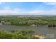 Scenic aerial view of a lakefront property offering serene waterfront living with city skyline in the distance at 4109 Arbor Spring Ct, Belmont, NC 28012