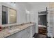 Bathroom features a granite countertop, white cabinets, and views into the walk-in shower at 4109 Arbor Spring Ct, Belmont, NC 28012