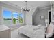 Bright bedroom featuring a modern chandelier and a large window with lake views at 4109 Arbor Spring Ct, Belmont, NC 28012