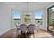 Elegant dining area with water views, chandelier, and ample natural light for a refined dining experience at 4109 Arbor Spring Ct, Belmont, NC 28012