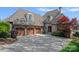 Stunning brick home with a three-car garage and manicured landscaping, offering a luxurious curb appeal at 4109 Arbor Spring Ct, Belmont, NC 28012
