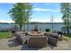 Charming lakeside fire pit area with comfortable seating and scenic views, perfect for outdoor gatherings at 4109 Arbor Spring Ct, Belmont, NC 28012