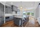 Elegant kitchen featuring gray cabinetry, a spacious island, and stainless appliances with water views from dining area at 4109 Arbor Spring Ct, Belmont, NC 28012