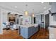 Open-concept kitchen featuring an island with sink, stainless appliances, and seamless flow to the living space at 4109 Arbor Spring Ct, Belmont, NC 28012