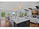 Beautiful kitchen with a central island, pendant lighting, and a view into the living area and water view dining area at 4109 Arbor Spring Ct, Belmont, NC 28012