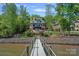 Expansive lake view with a private dock, a luxury home, and lush landscaping, a waterfront paradise at 4109 Arbor Spring Ct, Belmont, NC 28012