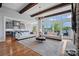 Spacious living room with hardwood floors, exposed beams, water views and a seamless transition to the kitchen at 4109 Arbor Spring Ct, Belmont, NC 28012