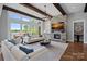 Bright living room with stone fireplace, beamed ceilings, water views, and elegant decor for comfortable living at 4109 Arbor Spring Ct, Belmont, NC 28012