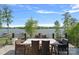 Outdoor dining area with stunning lake view and comfortable seating, perfect for entertaining guests or enjoying the scenery at 4109 Arbor Spring Ct, Belmont, NC 28012