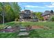 A beautiful stone home with a manicured lawn and a stone walkway in a desirable neighborhood at 4109 Arbor Spring Ct, Belmont, NC 28012
